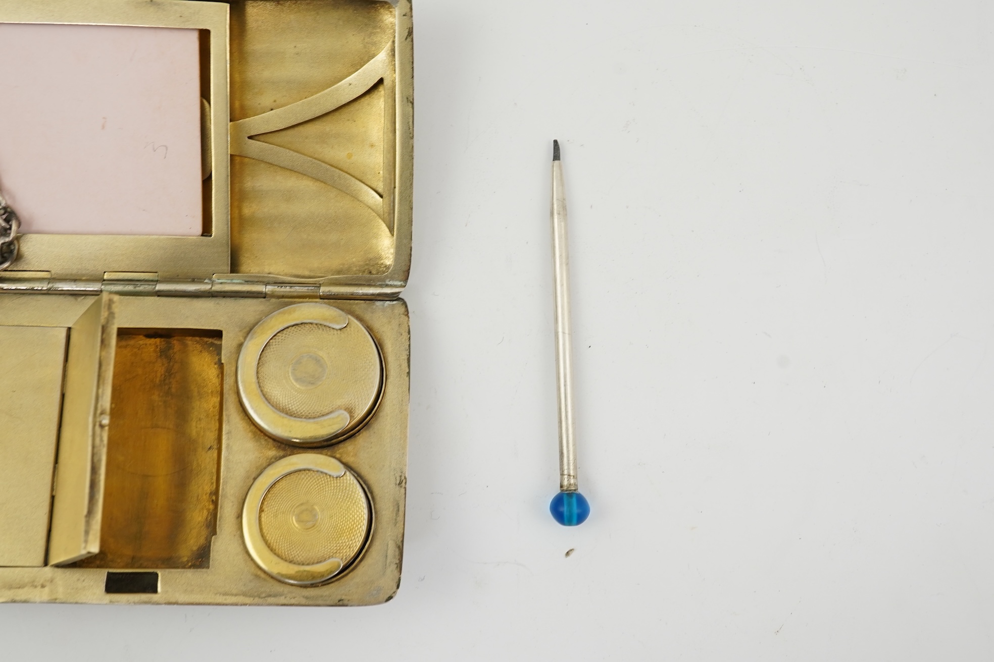 An early 20th century continental 800 standard silver combination, card, coin, aide memoir and pill case, with pencil and ribbed decoration, maker WK
